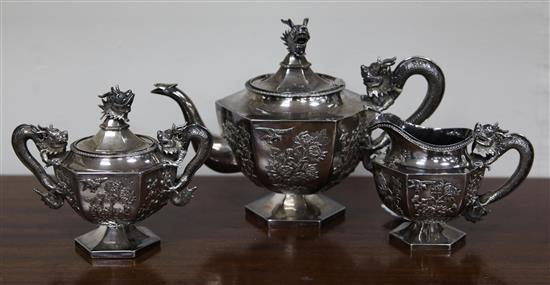 A late 19th/early 20th century Chinese Export three piece silver hexagonal pedestal tea set by Wang Hing, Hong Kong, gross 44 oz.